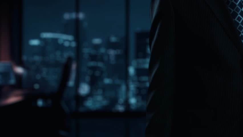 A businessman stands in a modern office, showcasing a digital interface that illustrates cost reduction strategies, featuring graphs, icons, and finance symbols. Qubit - Powered by Shutterstock - Get 15% off with code: PIKWIZARD15