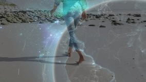 Woman walking along beach causing digital globe intensifying and illustrating tech connectivity. Coastline, technology, connectivity, innovative, serene, futurism, nature - Powered by Shutterstock - Get 15% off with code: PIKWIZARD15