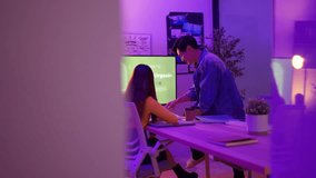 Product developers actively discuss with package designers, working all night to brainstorm ideas, sharing insights, and checking screen and paper graphic charts in the office at night. - Powered by Shutterstock - Get 15% off with code: PIKWIZARD15