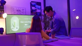 Product developers actively discuss with package designers, working all night to brainstorm ideas, sharing insights, and checking screen and paper graphic charts in the office at night. - Powered by Shutterstock - Get 15% off with code: PIKWIZARD15