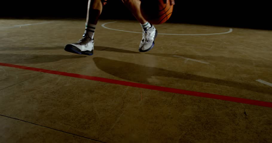 Basketball player entering court dribbling at red line doing crossover as media icons multiplying. Athlete, sports, dynamic, motion, performance, gymnasium, entertainment