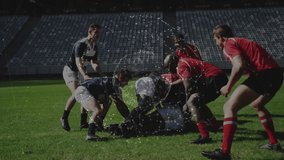 Red defenders driving navy-jersey carrier forming rugby ruck navy pack lifting ball for possession. Sports, teamwork, competition, outdoor, athleticism, strategic, intensity - Powered by Shutterstock - Get 15% off with code: PIKWIZARD15