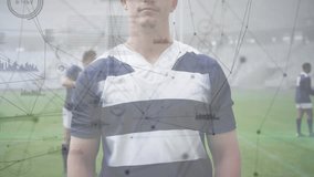 Rugby athlete standing initiating network graphics fading in as camera shifting for sports training. Athlete, teamwork, digital, connectivity, stadium, fitness, strength - Powered by Shutterstock - Get 15% off with code: PIKWIZARD15