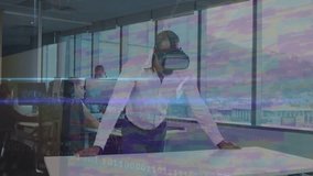 Businessman donning VR headset scanning table and demonstrating data streams in tech workspace. Technology, innovation, digital, collaboration, futurism, workspace, modern - Powered by Shutterstock - Get 15% off with code: PIKWIZARD15