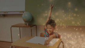 Boy raising right hand upon teacher prompt in class while golden particles swirling around desk. Student, classroom, learning, education, enthusiasm, celebration, curiosity - Powered by Shutterstock - Get 15% off with code: PIKWIZARD15