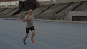 Male athlete initiating jog on blue track, with finance charts animating around prosthetic blade. Athlete, biomechanics, innovation, motion, technology, determination, progress - Powered by Shutterstock - Get 15% off with code: PIKWIZARD15