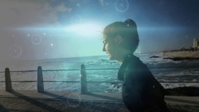 Runner starting seaside jog, showing wrist tracker and circular HUD tracking performance metrics. Fitness, outdoor, activewear, digital, wellness, technology, determination - Powered by Shutterstock - Get 15% off with code: PIKWIZARD15