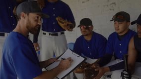 Baseball coach entering dugout gathering team, planning play with animated lineup chart overlay. Athletics, teamwork, strategy, mentorship, coaching, sportsmanship, training - Powered by Shutterstock - Get 15% off with code: PIKWIZARD15