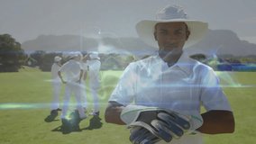 Cricket player stepping outfield toward camera and tightening gloves for match with digital effects. Athletic, team, sport, action, modern, outdoor, determination - Powered by Shutterstock - Get 15% off with code: PIKWIZARD15