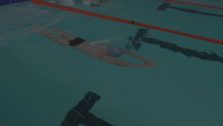 Man pushing off wall gliding underwater along red lane rope analyzing tech data bars sliding. Swimmer, aquatic, motion, technology, data visualization, digital, futuristic - Powered by Shutterstock - Get 15% off with code: PIKWIZARD15