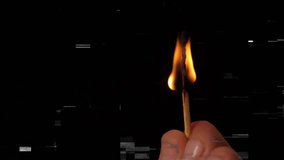 Hand lighting matchstick causing flame flickering elongating shrinking while showing combustion. Fire, chiaroscuro, darkness, ignition, decay, intensity, volatility - Powered by Shutterstock - Get 15% off with code: PIKWIZARD15