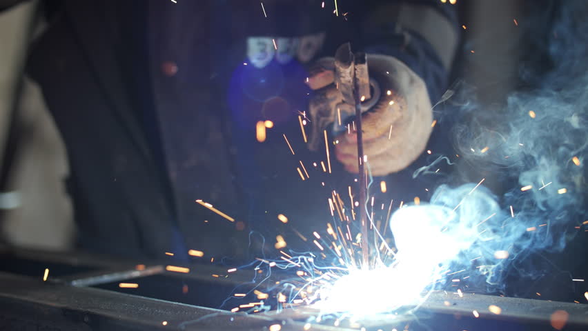 Welding process with bright sparks and smoke