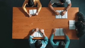 Top view of prayer hold each other support while prays to god at table with bible and cross placed with faith, spirituality and religion. Aerial view of diverse people holding and praying. Symposium. - Powered by Shutterstock - Get 15% off with code: PIKWIZARD15