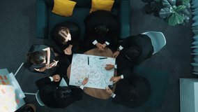 Top down aerial view of people putting hands together and clapping hands to celebrate successful project while using mind map to brainstorm idea. Skilled team stacking hands together. Directorate. - Powered by Shutterstock - Get 15% off with code: PIKWIZARD15