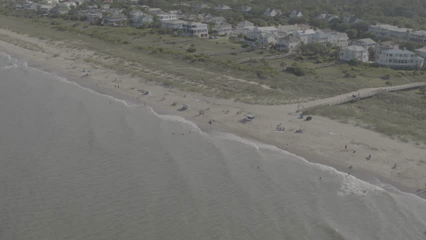 Beautiful 4K aerial drone footage showcasing luxurious waterfront homes on Hilton Head Island, South Carolina. The sweeping cinematic shot captures elegant coastal architecture surrounded by calm blue