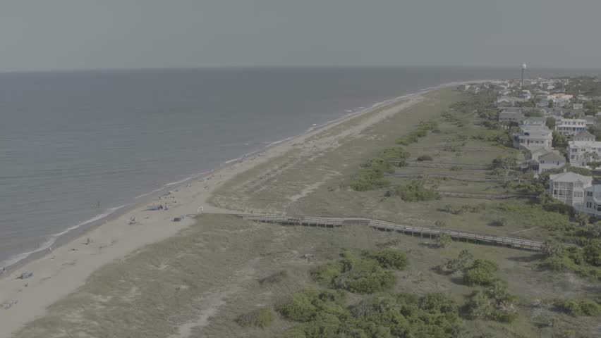 Beautiful 4K aerial drone footage showcasing luxurious waterfront homes on Hilton Head Island, South Carolina. The sweeping cinematic shot captures elegant coastal architecture surrounded by calm blue