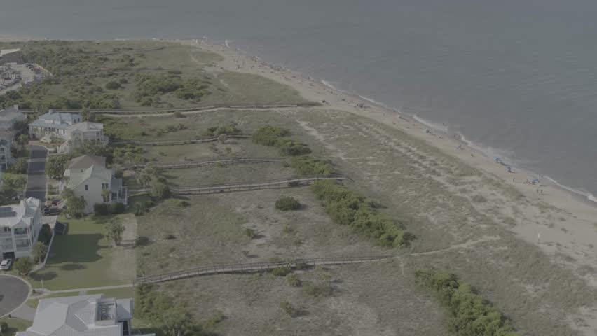 Beautiful 4K aerial drone footage showcasing luxurious waterfront homes on Hilton Head Island, South Carolina. The sweeping cinematic shot captures elegant coastal architecture surrounded by calm blue