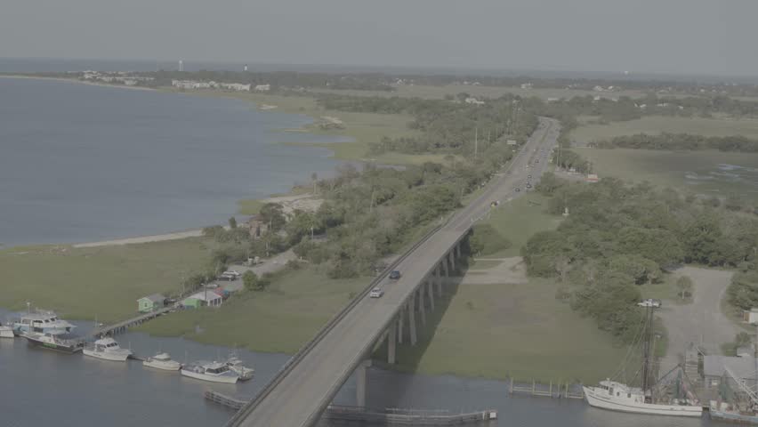 Beautiful 4K aerial drone footage showcasing luxurious waterfront homes on Hilton Head Island, South Carolina. The sweeping cinematic shot captures elegant coastal architecture surrounded by calm blue