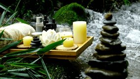 Spa setting with candles, essential oils, and zen stones by a serene, flowing stream. A tranquil scene for relaxation, wellness, meditation, and natural beauty. - Powered by Shutterstock - Get 15% off with code: PIKWIZARD15
