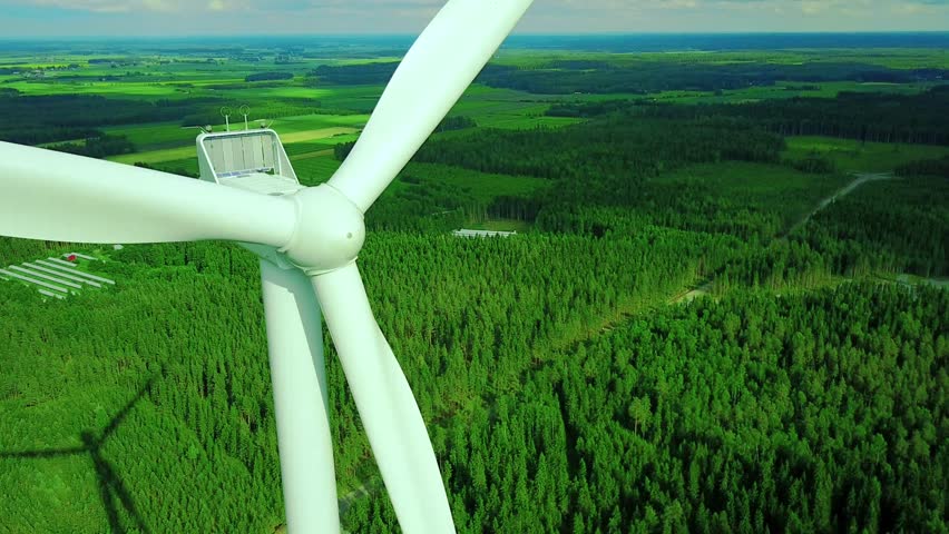 Aerial view of windmills in summer forest in Finland. Wind turbines for electric power with clean and Renewable Energy 