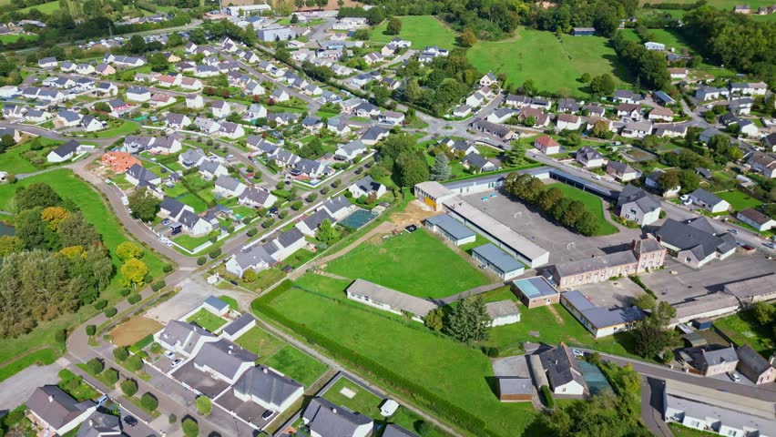 Top-down drone perspective view of center of Saint-Pierre-la-Cour commune with homes, Mayenne, France.