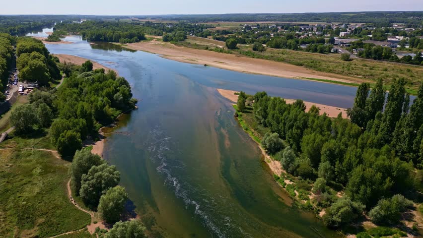 Loire River near Amboise, wide river, sandbanks, and lush green banks in Loire Valley, France. Aerial drone forward
