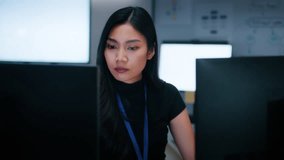 Asian Female Software Developer sit at desk working on Dual Screens, Writing Code, developing software program, Ai Machine learning Data development in office at night. Tech Startup and Innovative. - Powered by Shutterstock - Get 15% off with code: PIKWIZARD15