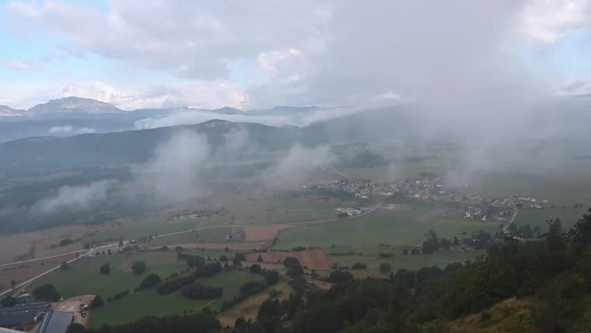 a rainy cloud over Vassieux-en-Vercors, pre-alps mountains in department of Drome in France- top view