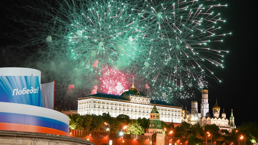 Moscow Kremlin (with decorations for the holiday May 9) and fireworks in honor of Victory Day celebration (WWII), Russia. TRANSLATION: Victory!. 4K, time lapse 