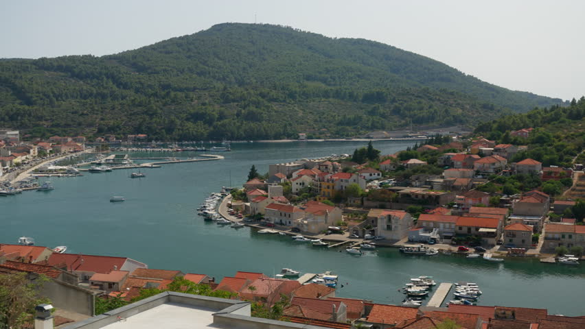 The seaside town of Vela Luka on Korcula island in Dalmatia, Croatia. A tourist destination on the Adriatic coast with a large bay, a marina for boats and yachts, and historic houses.