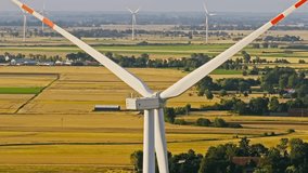 Slow motion drone view, wind turbine rotate in Poland farmland, golden sunset - Powered by Shutterstock - Get 15% off with code: PIKWIZARD15