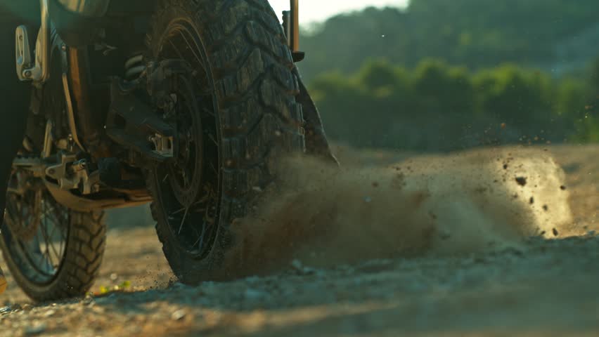 Super Slow Motion Shot of an Off-Road Motorcycle Spinning Its Rear Wheel and Throwing Dirt Into the Air. Captured at 1000fps to Highlight Power, Motion, and Explosive Terrain Impact.
