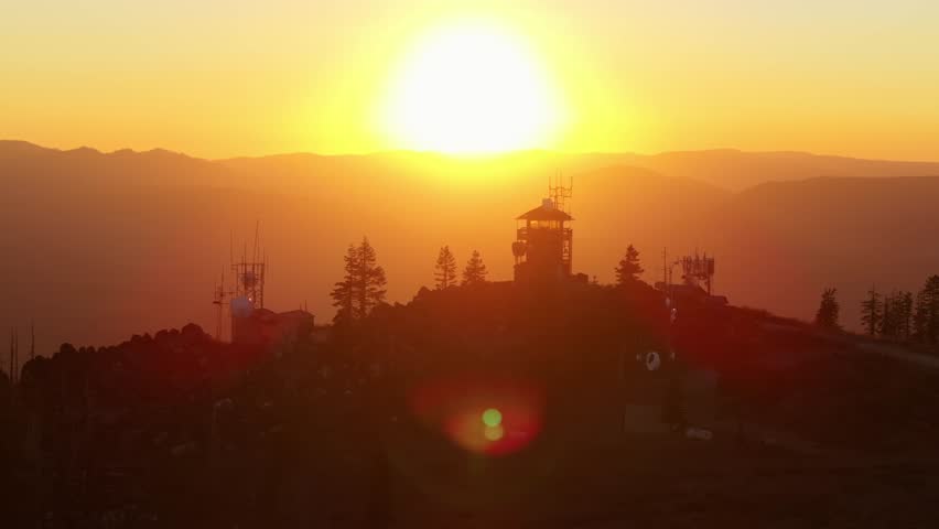 Fire lookout tower during Californian sunset, warm serene atmosphere