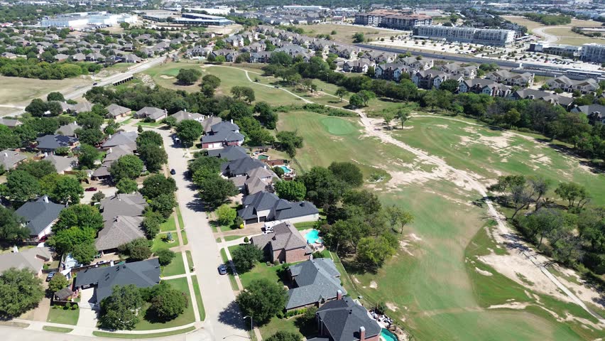 Suburban homes, central golf course, new development apartment complex with pool in North Richland Hills, Texas. Commercial buildings, highway border the distant horizon of growing suburbs Dallas. USA
