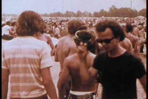 1970s - Hippies smoke dope and pot and do drugs at a rock concert in the 1970s.