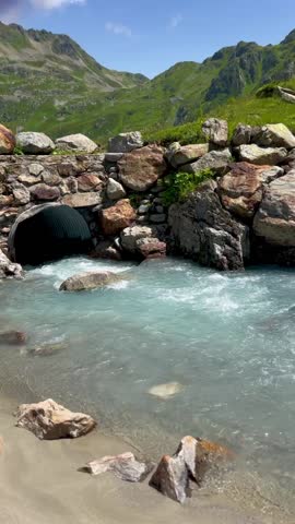Mountain stream flowing through rocks in the Alps