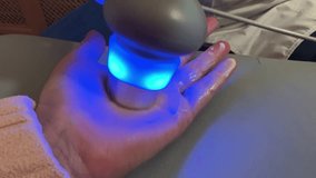 Ultrasound physiotherapy treatment on female hand with blue light device during arthritis rehabilitation in medical clinic room - Powered by Shutterstock - Get 15% off with code: PIKWIZARD15