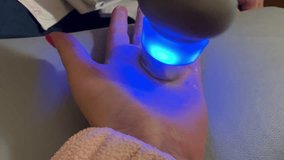Ultrasound physiotherapy treatment on female hand with blue light device during arthritis rehabilitation in medical clinic room - Powered by Shutterstock - Get 15% off with code: PIKWIZARD15