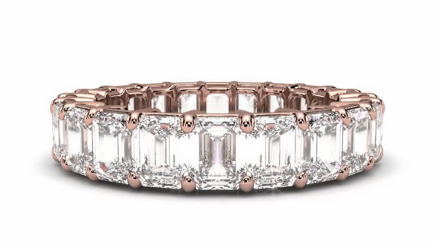 A stunning, seamlessly looping close-up of a luxury eternity ring featuring brilliant, continuous round-cut diamonds set in a pink gold (or rose gold) band. The ring is shown in a smooth, captivating 