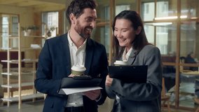 Multiethnic two relaxed business partners discussing documents holding coffee drink Korean businesswoman Caucasian businessman happy friendly teamwork clipboard office work break ideas strategy report - Powered by Shutterstock - Get 15% off with code: PIKWIZARD15