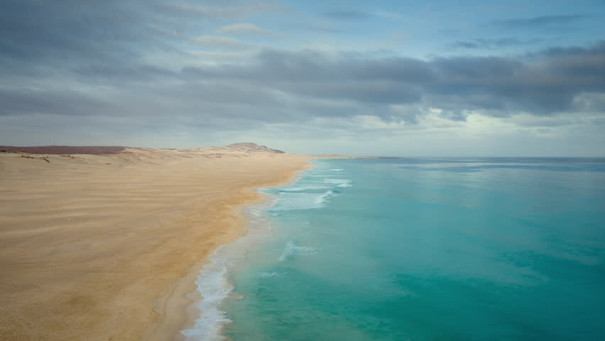 Aerial view of Chaves Beach,showcasing endless white sand, turquoise waves, and a pristine, untouched coastline under a beautiful sky,Boa Vista, Cape Verde.