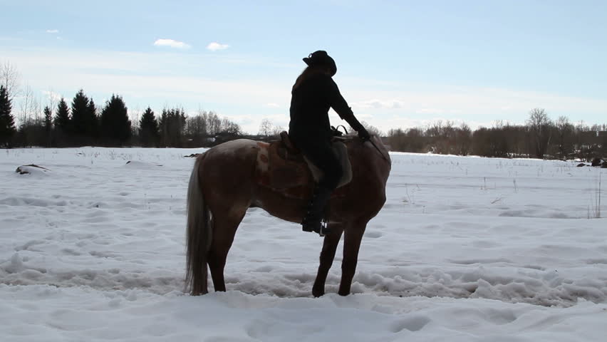 Girl cowboy on a horse - a step backwards