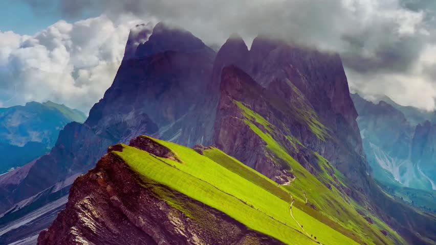 Green cloud floating above majestic mountain peaks in a surreal landscape.