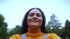 Happy young woman twirls in the park. Joyful and excited young beauty laughs and smiles, holds a camera, twirls, takes selfies, and strives for her dreams. - Powered by Shutterstock - Get 15% off with code: PIKWIZARD15