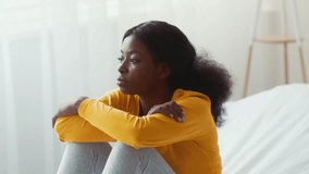 Young pregnant woman reflecting on motherhood in a cozy home setting - Powered by Shutterstock - Get 15% off with code: PIKWIZARD15