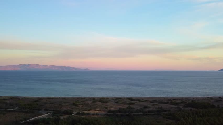 beauty of the Datça Peninsula on the way to the ancient city of Knidos. This footage captures the serene coastal landscapes, the vast expanse of the Aegean Sea, and the distant mountains under a beaut