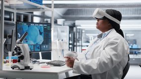 Black woman using VR headset to explore 3D interactive experiment in laboratory, biochemistry and nanotechnology study. Expert uses virtual reality glasses and gadgets for science. Camera B. - Powered by Shutterstock - Get 15% off with code: PIKWIZARD15