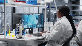 African american scientist uses magnifying glass to check Petri dish matter in biolab, laboratory experiment emphasizes microbiology and genetics research. Advancing medical research. Camera B. - Powered by Shutterstock - Get 15% off with code: PIKWIZARD15