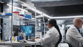 African american scientist uses magnifying glass to check Petri dish matter in biolab, laboratory experiment emphasizes microbiology and genetics research. Advancing medical research. Camera A. - Powered by Shutterstock - Get 15% off with code: PIKWIZARD15