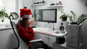Remote worker in Christmas hat creating illustrations with AI generator at home office. Scene shows technology, digital art, freelance work and holiday inspiration indoors. Magical image creation AI - Powered by Shutterstock - Get 15% off with code: PIKWIZARD15